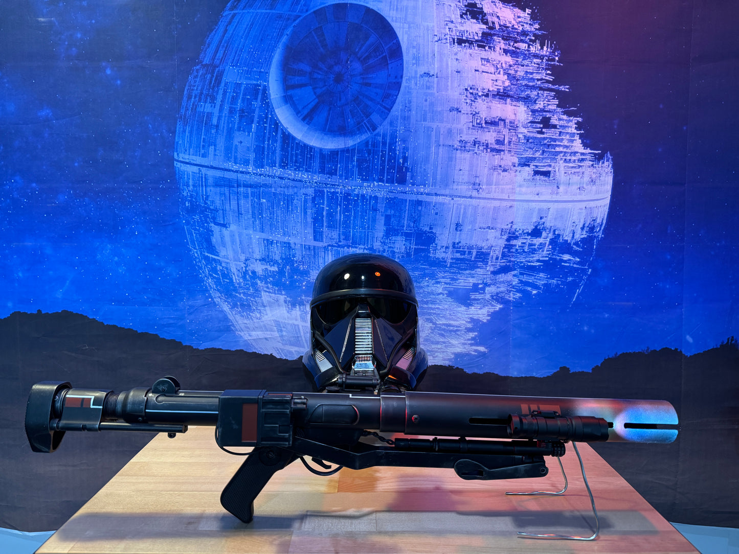 Helmet and weapon with Death Star in the background