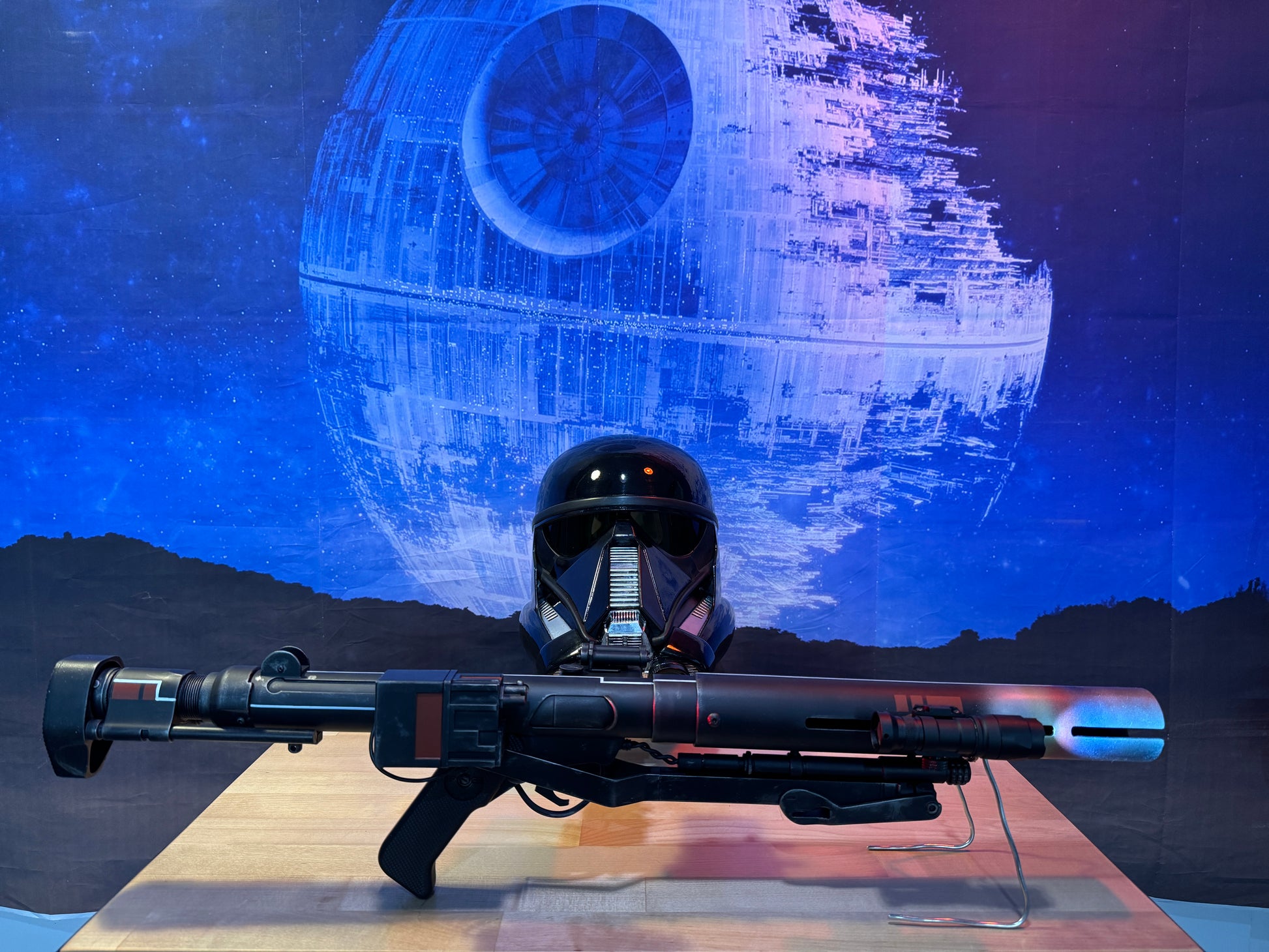 Helmet and weapon with Death Star in the background